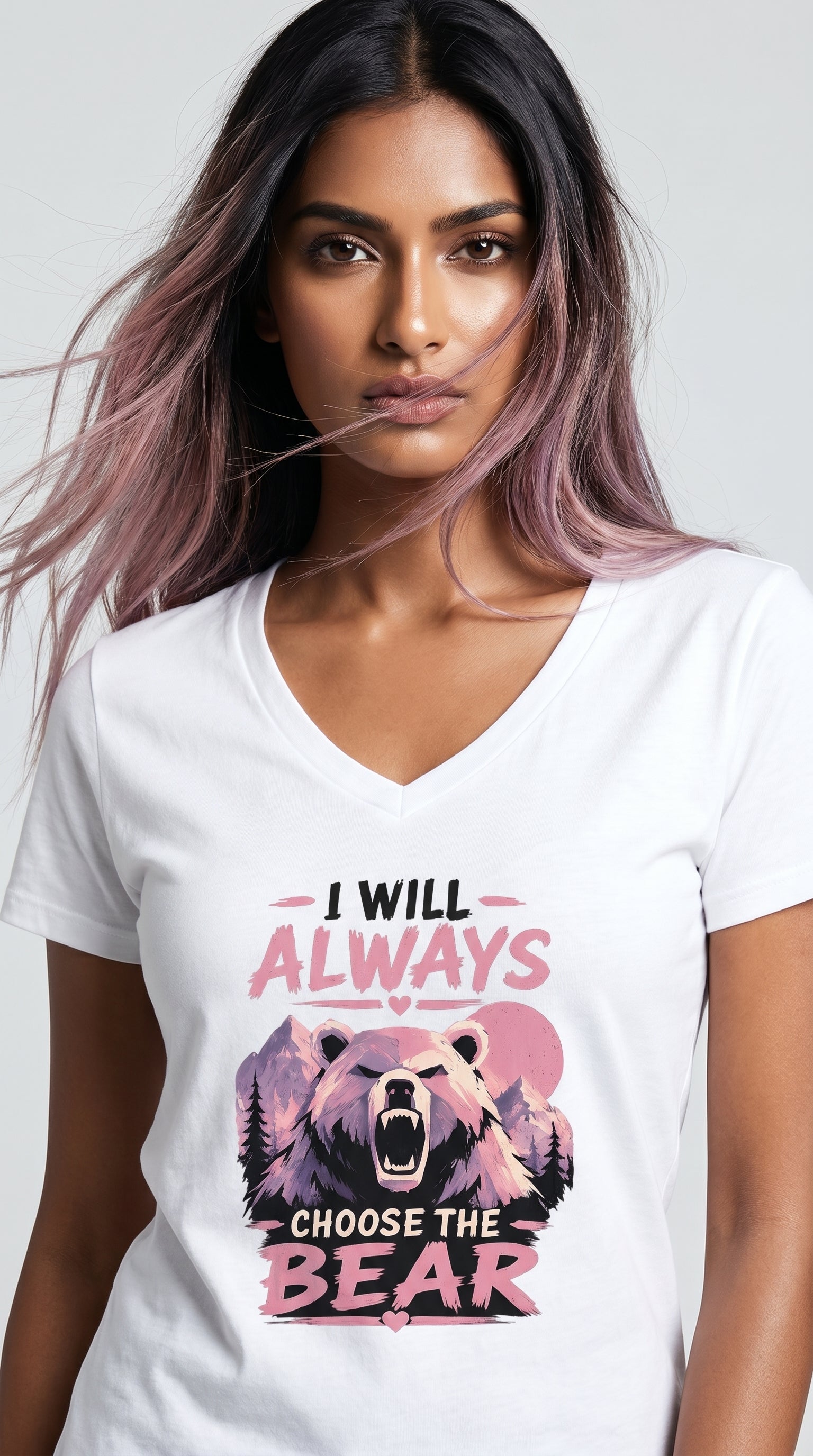 Woman wearing a white graphic t-shirt featuring a pink and purple bear design with the phrase "I Will Always Choose the Bear" against a mountain landscape backdrop.