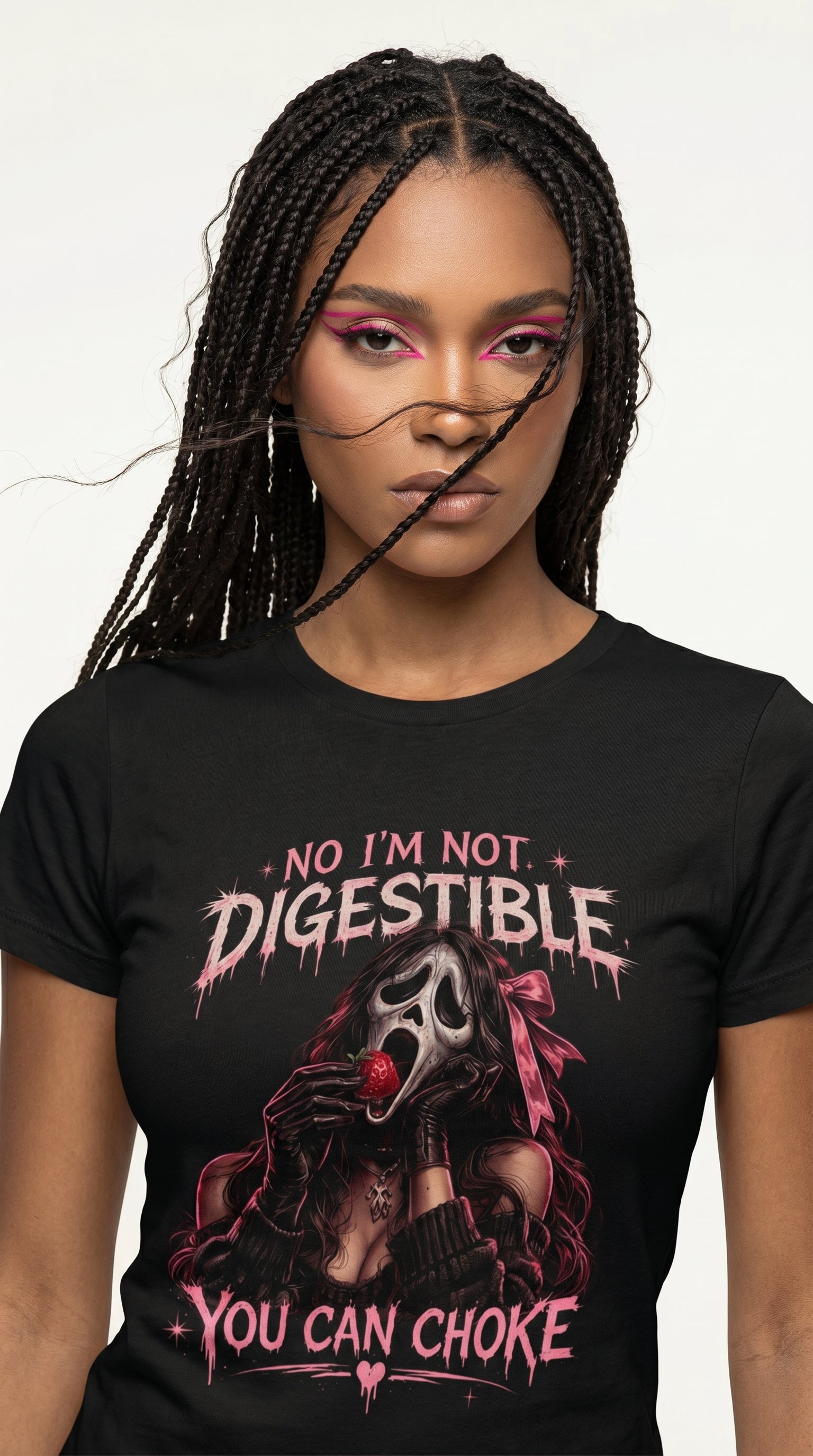 Woman wearing a black graphic t-shirt featuring a feminine horror-inspired character holding a strawberry with the phrase " No i'm not Digestible, You can Choke."